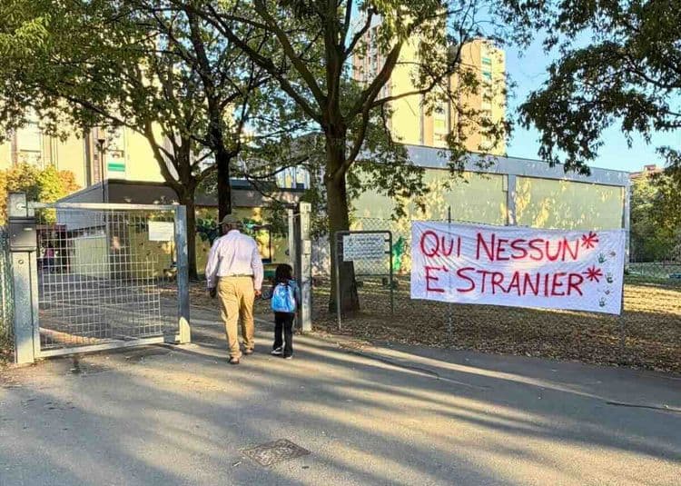A father and daughter entering the school